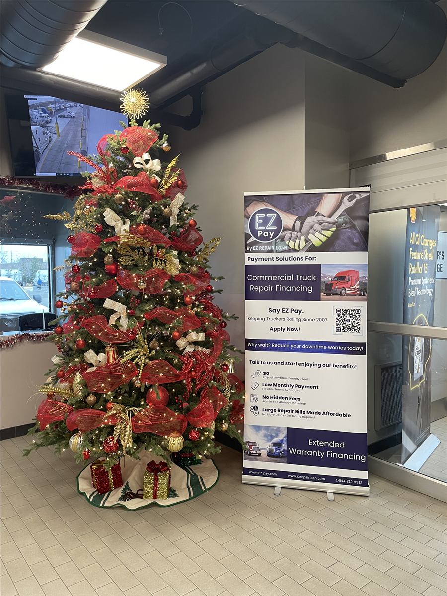 Holiday tree beside an EZ Pay banner