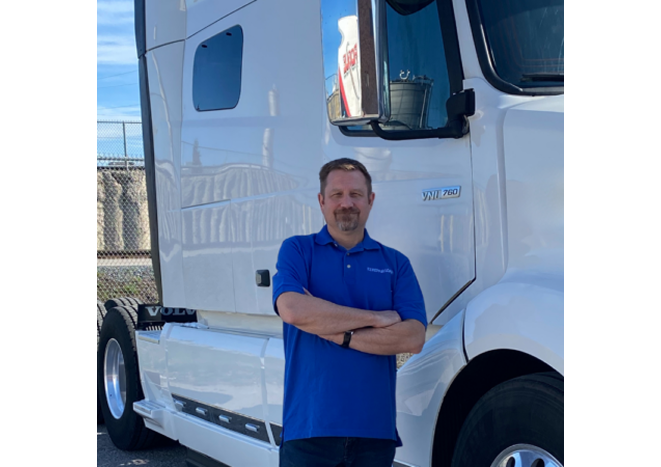 EZ Pay representative standing in front of a white tractor